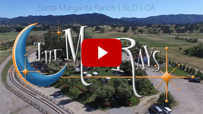 the moonrays logo overlayed on top of a wedding scene set at a ranch in santa margarita california